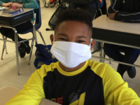 A student at Adams Elementary School wears their new face mask.