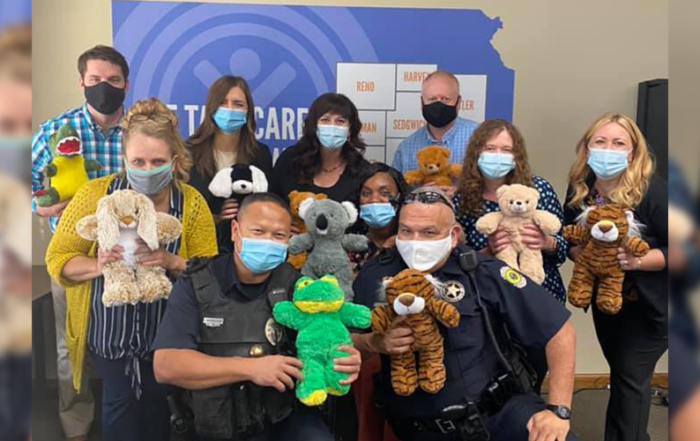 Volunteers gift local police officers comfort kits to give to children they encounter through their work.