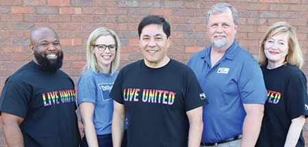 The United Way management team poses together in their Live United t-shirts.