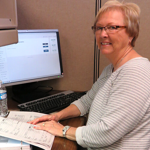 An IRS certified volunteer helps a client complete their taxes for free.
