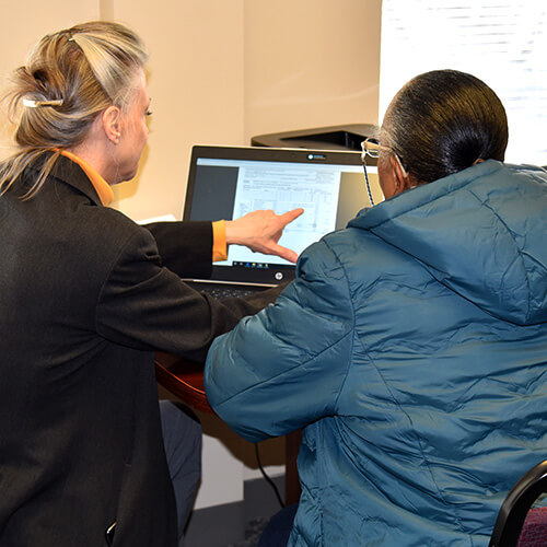 A volunteer helps a client file their taxes for free through our Volunteer Income Tax Assistance program.