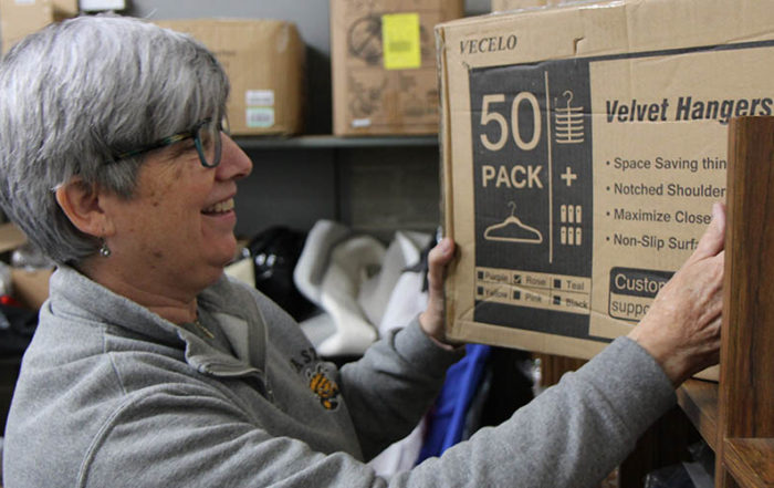 A woman looks at products available at the United Way Give Items of Value Warehouse.