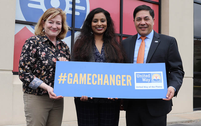 United Way Vice President of Marketing Angie Prather, Dr. Mythili Menon from Wichita State University and Pete Najera, United Way President and CEO stand together outside the United Way office.