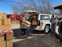 Nonprofit reps pose with United Way staff in front of a van full of toys they received from United Way.