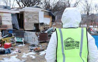 Volunteers approach a homeless encampment as part of the 2025 Point-in-Time Count outreach event.