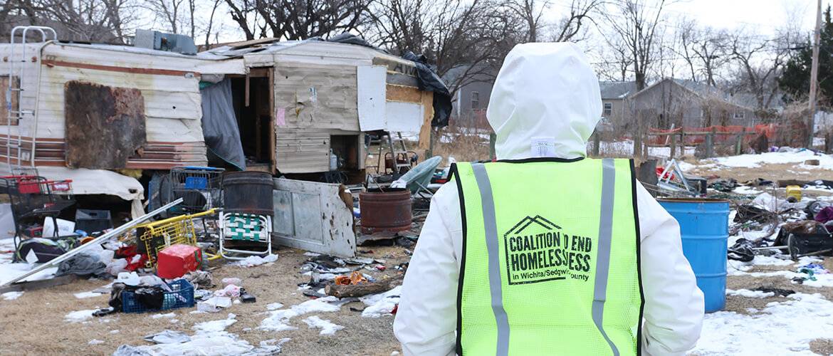 Volunteers approach a homeless encampment as part of the 2025 Point-in-Time Count outreach event.