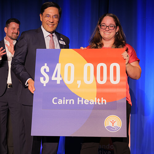 United Way President Pete Najera presents Cairn Health with a $40,000 investment through Impact on the plains.