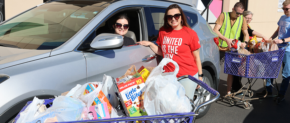 United Way of the Plains staff accept donations at a food drive.