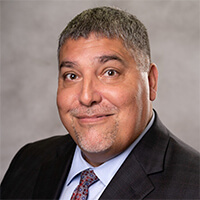 Headshot of Gil Alvarez. 