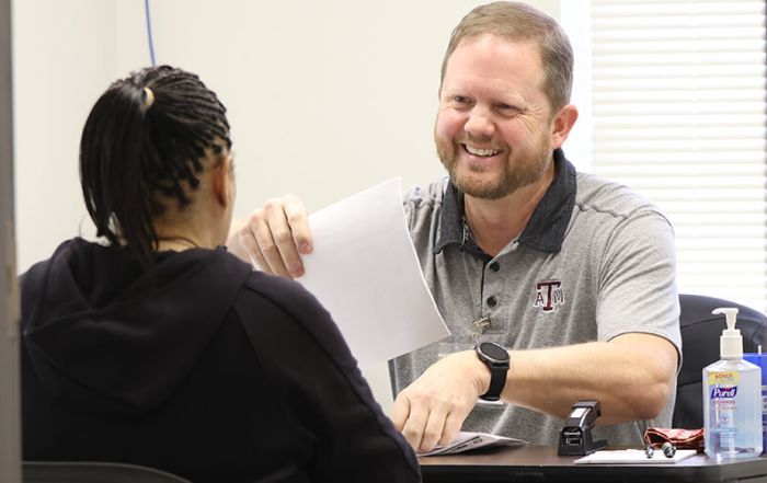 A IRS-certified tax volunteer helps a woman file her taxes in-person through United Way's free tax filing services.