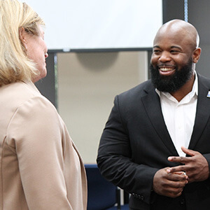 Abel Frederic chats with colleagues on his first day at United Way.