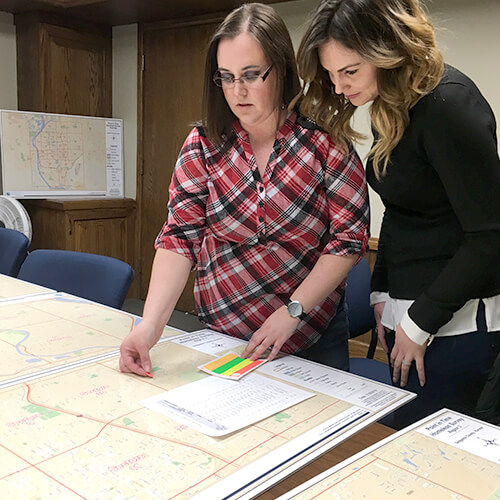 Two women working on a map for the annual Point-in-Time homeless count.